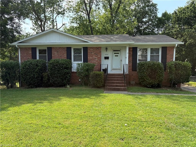 2504 Denise Dr, Greensboro, NC 27407 - view of front facade with a front lawn and brick siding