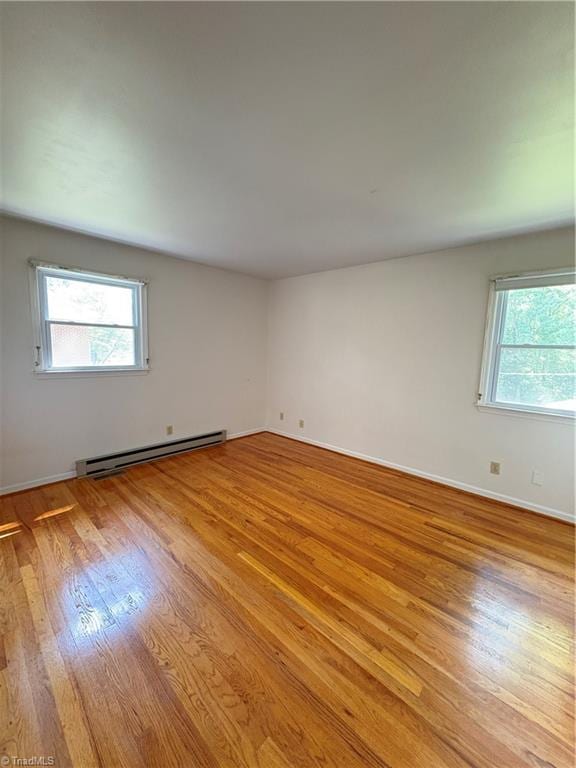 2504 Denise Dr, Greensboro, NC 27407 - spare room with baseboard heating, plenty of natural light, and light wood-style flooring