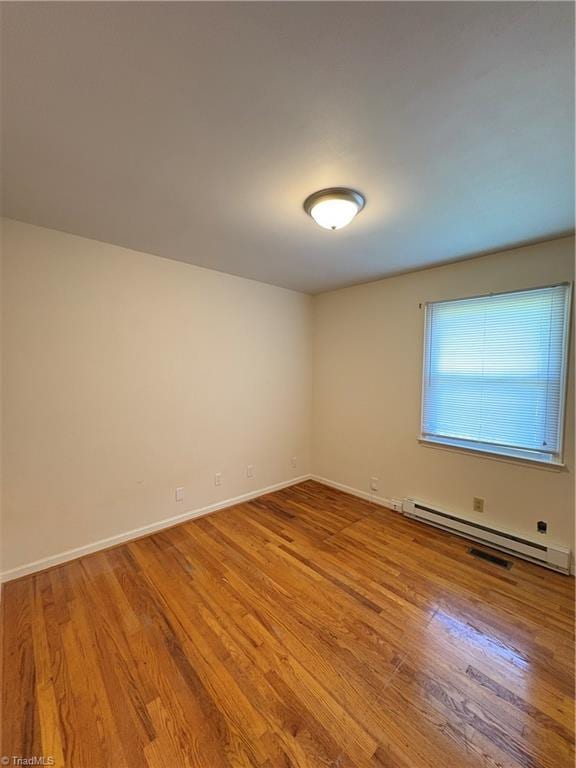 2504 Denise Dr, Greensboro, NC 27407 - spare room with baseboard heating and wood finished floors