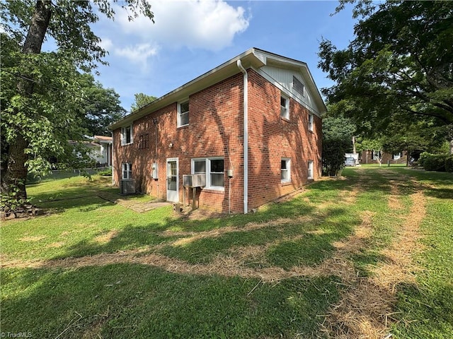 2504 Denise Dr, Greensboro, NC 27407 - view of side of home with brick siding, a lawn, and cooling unit