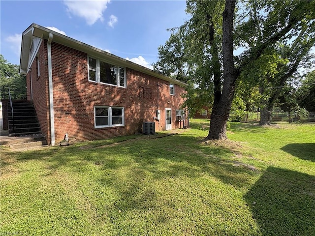 2504 Denise Dr, Greensboro, NC 27407 - rear view of property with brick siding, stairway, and a lawn