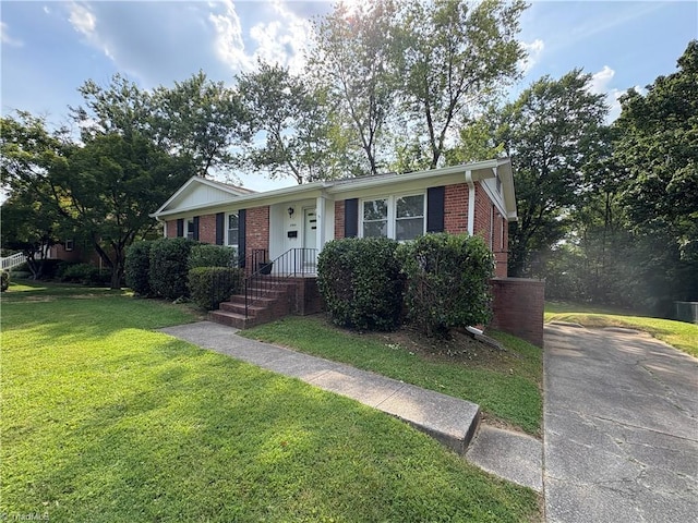 2504 Denise Dr, Greensboro, NC 27407 - ranch-style house with brick siding, a front yard, and concrete driveway