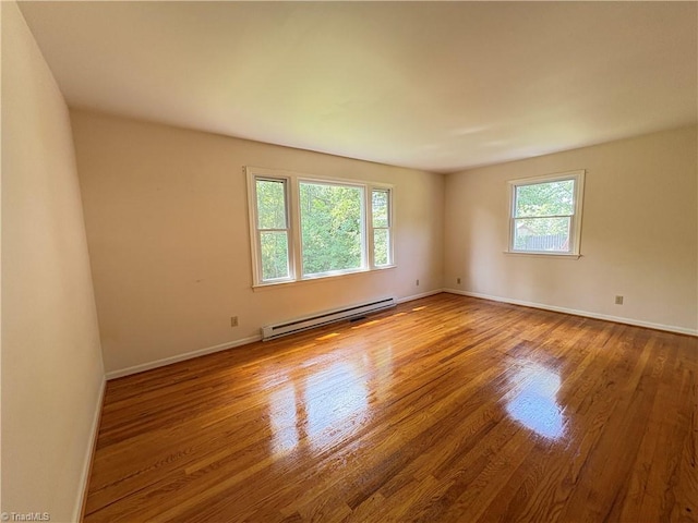 2504 Denise Dr, Greensboro, NC 27407 - spare room featuring a baseboard radiator and wood finished floors
