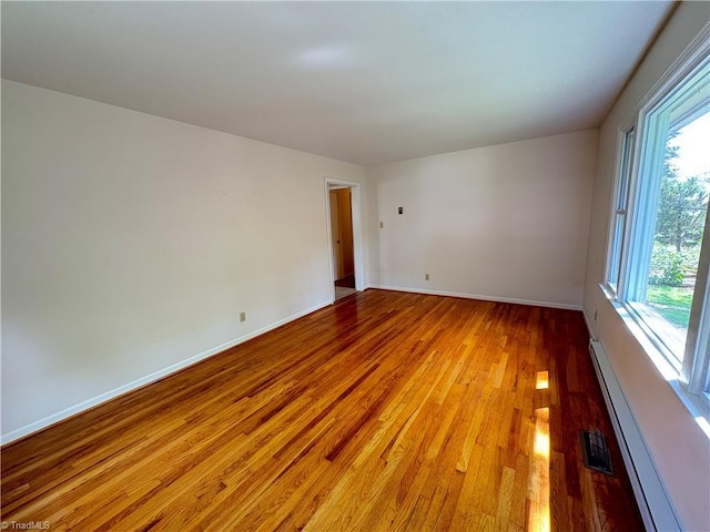 2504 Denise Dr, Greensboro, NC 27407 - empty room featuring a baseboard heating unit and light wood finished floors