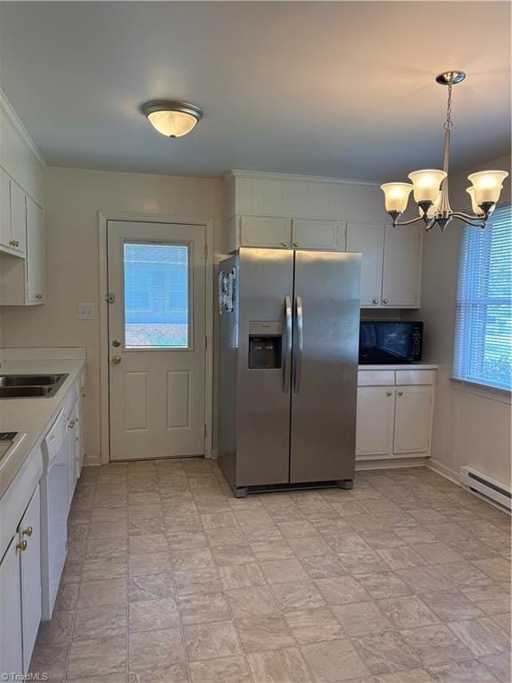 2504 Denise Dr, Greensboro, NC 27407 - kitchen with stainless steel fridge, a chandelier, black microwave, light countertops, and dishwasher