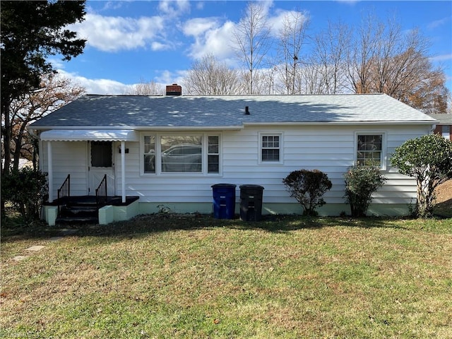 back of house featuring a yard