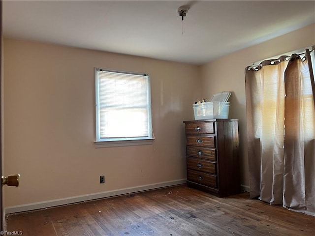 unfurnished bedroom with dark hardwood / wood-style floors