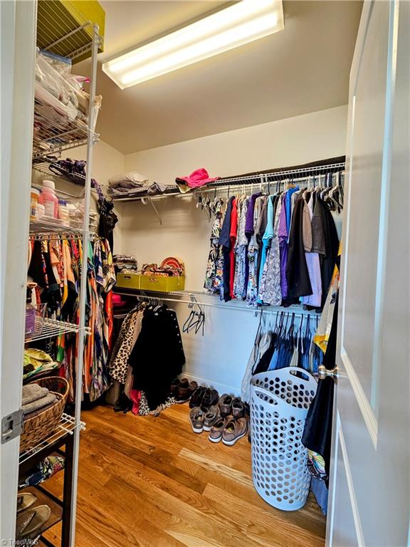 spacious closet featuring hardwood / wood-style floors