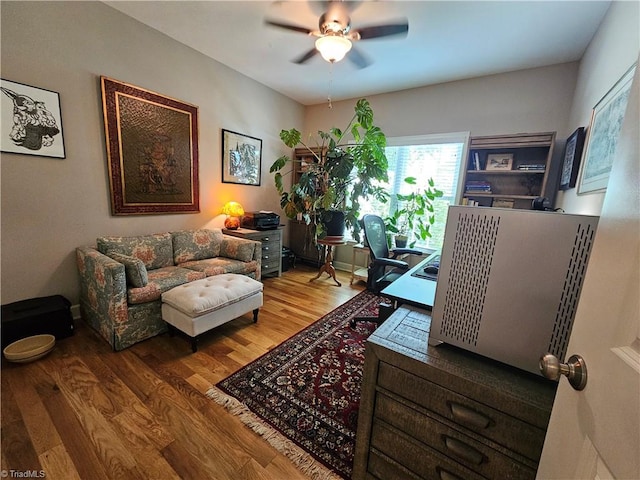 office with ceiling fan and hardwood / wood-style flooring