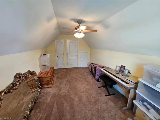 interior space with dark colored carpet, ceiling fan, and lofted ceiling