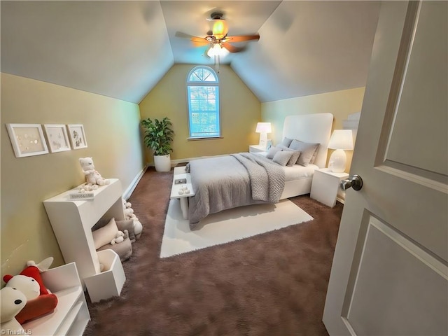 bedroom featuring ceiling fan, dark carpet, and vaulted ceiling