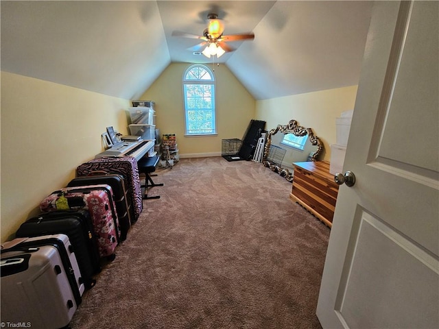 carpeted office space featuring ceiling fan and lofted ceiling