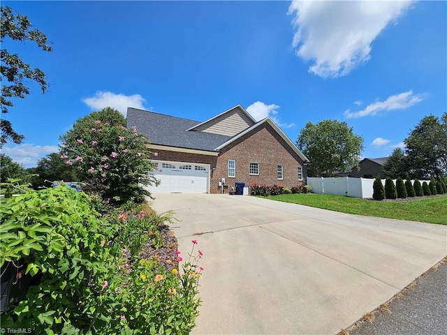 view of side of home with a yard and a garage