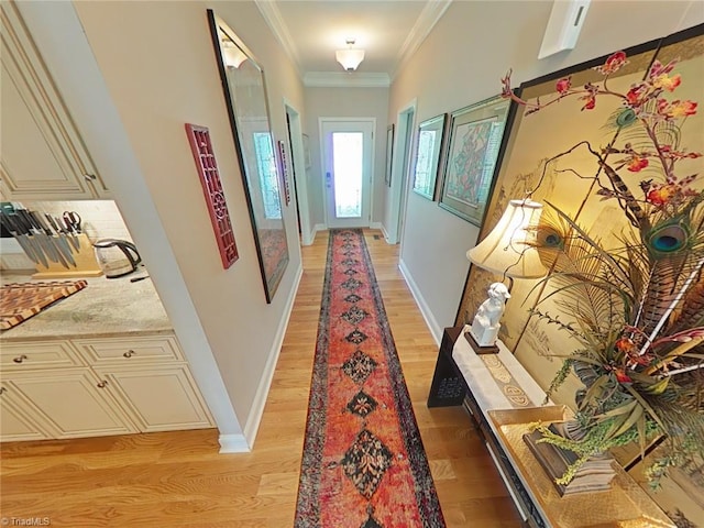 hallway featuring crown molding and light wood-type flooring