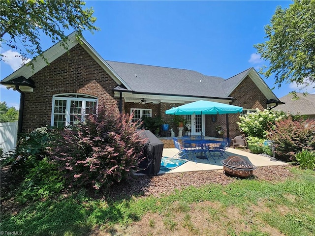 back of house featuring a patio area, ceiling fan, and an outdoor fire pit