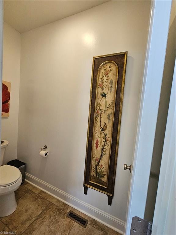 bathroom with tile patterned flooring and toilet