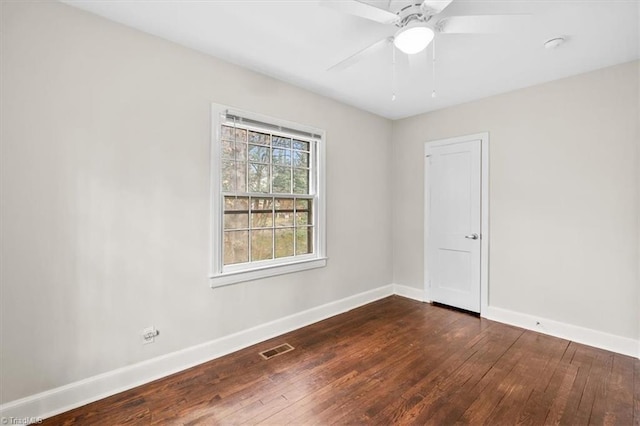 spare room with dark hardwood / wood-style floors and ceiling fan