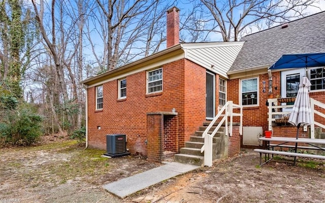 rear view of property featuring cooling unit