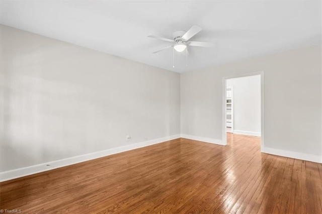 empty room featuring ceiling fan and hardwood / wood-style floors