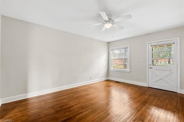 empty room with ceiling fan and hardwood / wood-style floors