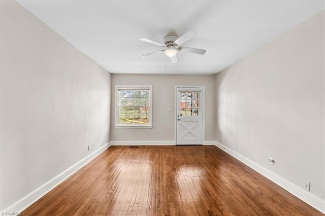 unfurnished room with hardwood / wood-style flooring and ceiling fan