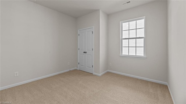 unfurnished room with light colored carpet