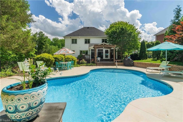 8116 Glengarriff Rd, Clemmons, NC 27012 - swimming pool featuring a pergola, a patio, a wooden deck, and fence