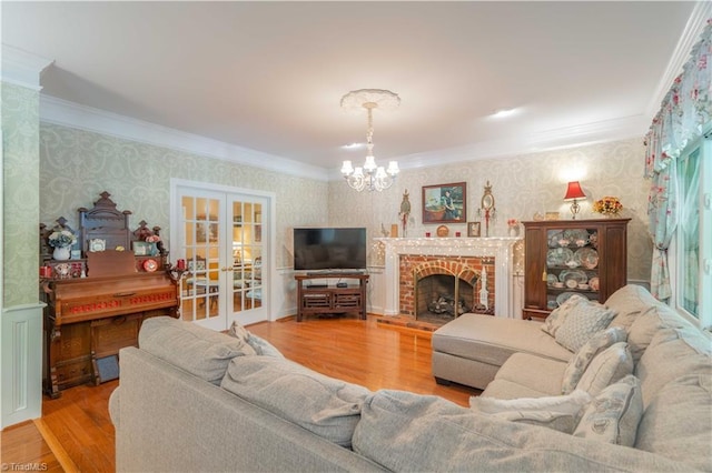 8116 Glengarriff Rd, Clemmons, NC 27012 - living area with wallpapered walls, ornamental molding, a chandelier, wood finished floors, and french doors