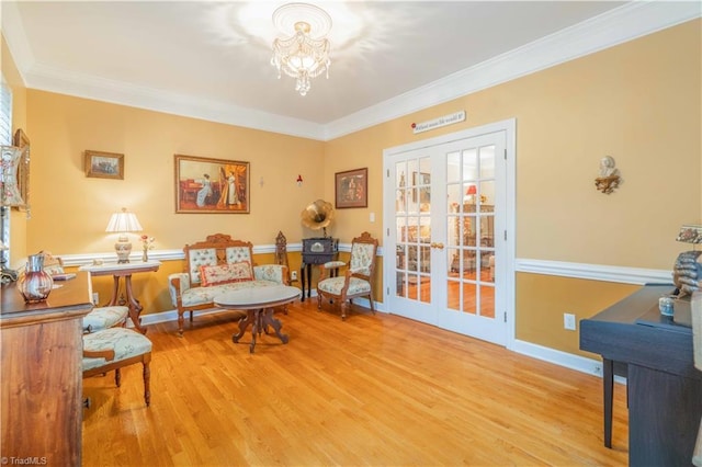 8116 Glengarriff Rd, Clemmons, NC 27012 - sitting room with wood finished floors, a chandelier, ornamental molding, french doors, and baseboards