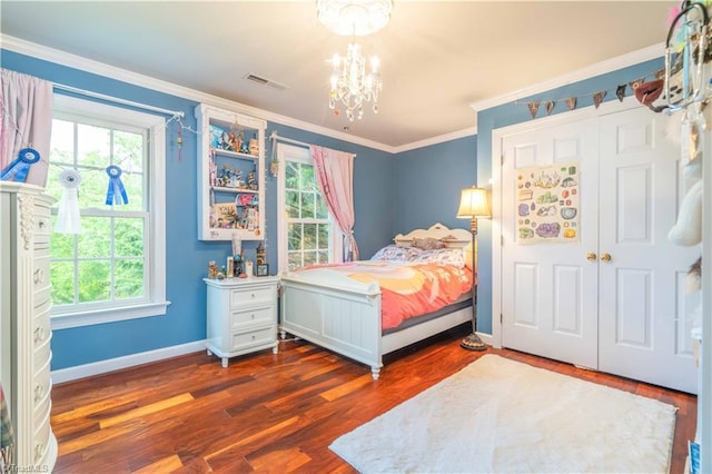 8116 Glengarriff Rd, Clemmons, NC 27012 - bedroom featuring multiple windows, a chandelier, wood finished floors, and crown molding