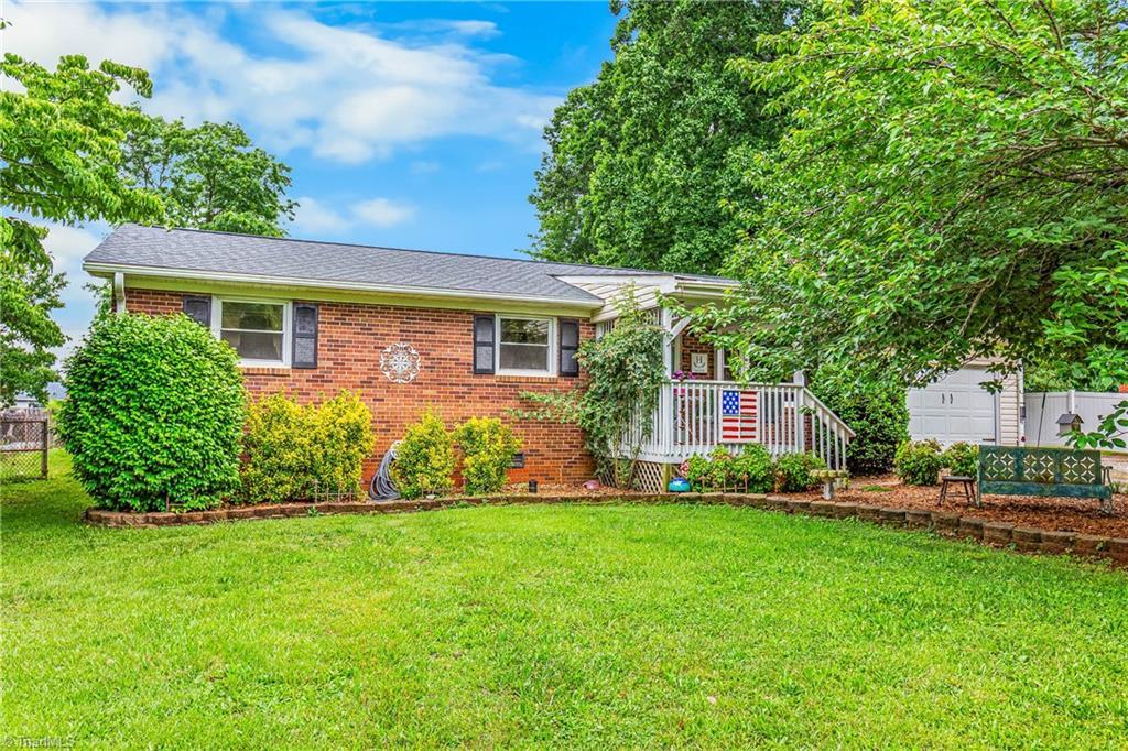 3972 Shadydale Acres Ln, Trinity, NC 27370 - view of front of home with a front lawn, brick siding, and roof with shingles