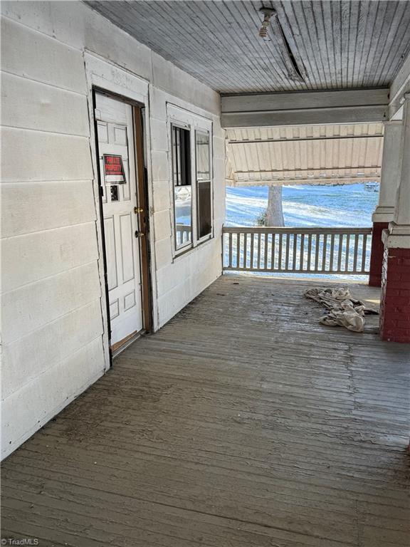 wooden terrace with a porch