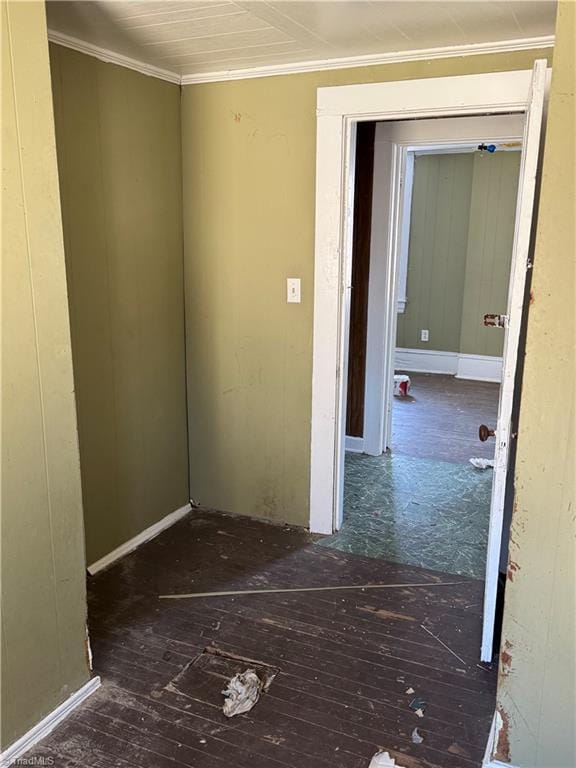 spare room featuring dark hardwood / wood-style flooring and crown molding