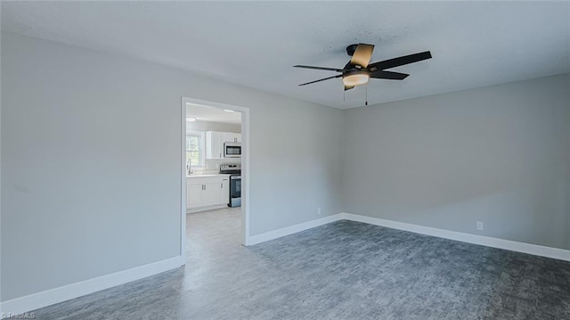 empty room with sink, dark hardwood / wood-style floors, and ceiling fan