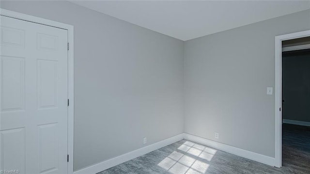 unfurnished room featuring wood-type flooring