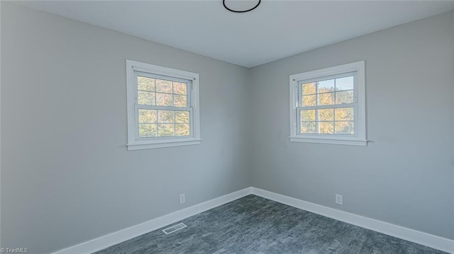 unfurnished room featuring plenty of natural light