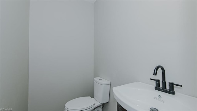 bathroom featuring sink and toilet