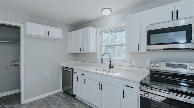 kitchen featuring crown molding, sink, white cabinetry, and stainless steel appliances