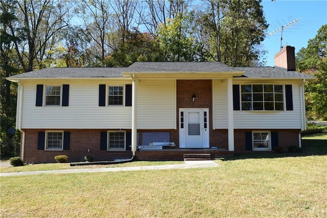 raised ranch with a front yard