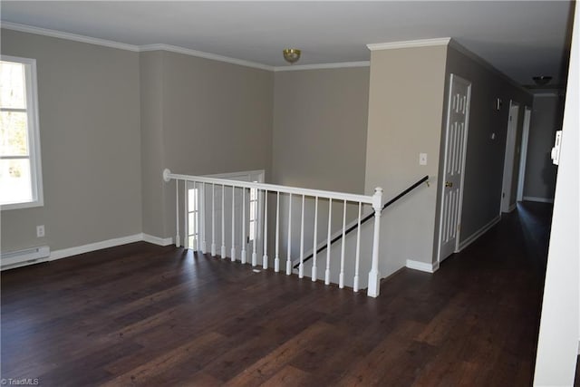 hall with a baseboard heating unit, ornamental molding, and dark wood-type flooring