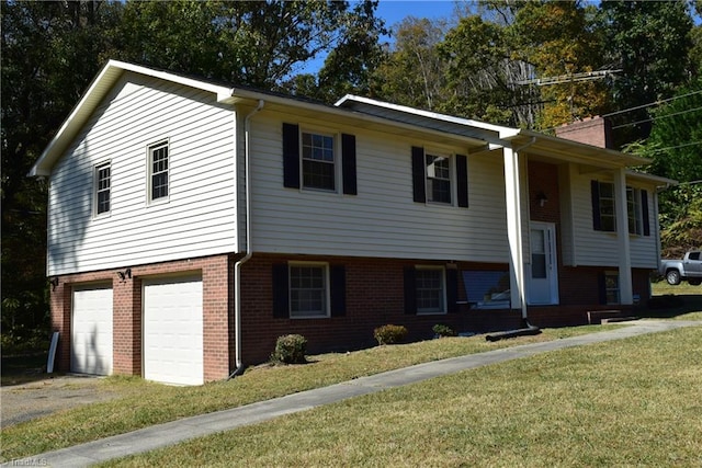 bi-level home with a garage and a front lawn