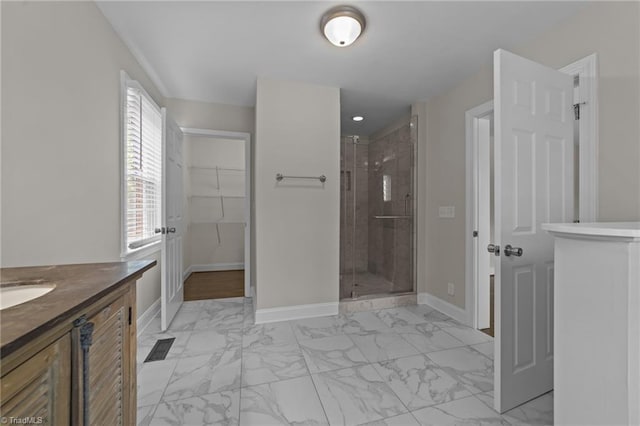 1810 Elm St N, Greensboro, NC 27408 - full bathroom with marble finish flooring, a stall shower, vanity, and a walk in closet