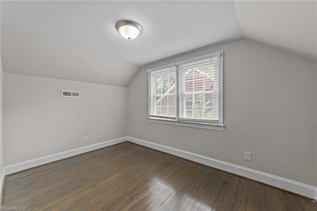 1810 Elm St N, Greensboro, NC 27408 - additional living space with vaulted ceiling and dark wood-style flooring