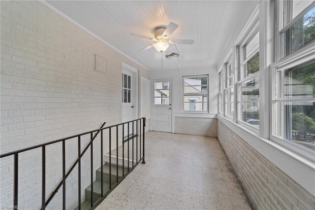 1810 Elm St N, Greensboro, NC 27408 - unfurnished sunroom featuring brick wall and ornamental molding