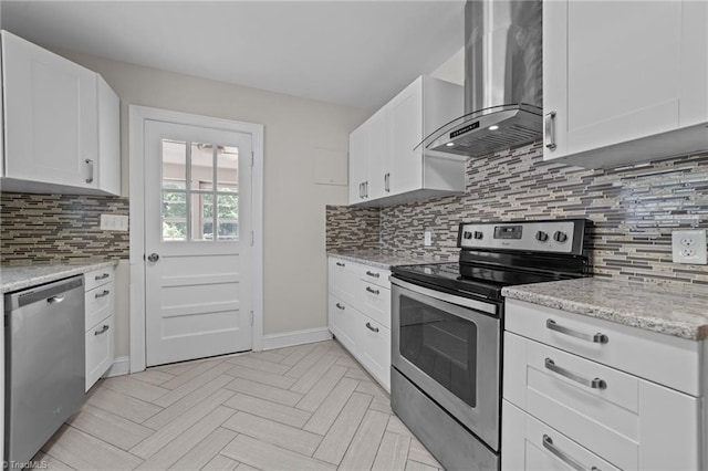 1810 Elm St N, Greensboro, NC 27408 - kitchen with wall chimney range hood, stainless steel appliances, backsplash, white cabinetry, and light stone countertops