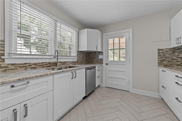 1810 Elm St N, Greensboro, NC 27408 - kitchen featuring dishwasher, backsplash, healthy amount of natural light, and white cabinets