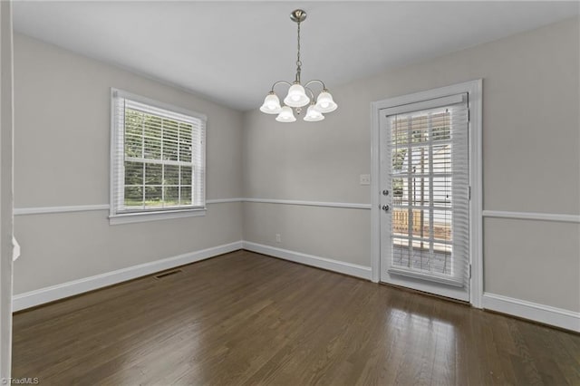 1810 Elm St N, Greensboro, NC 27408 - unfurnished dining area featuring a chandelier, plenty of natural light, and wood finished floors