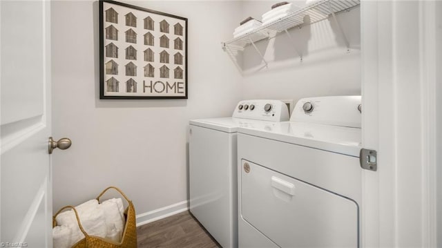 laundry area featuring washer and dryer and dark wood-type flooring