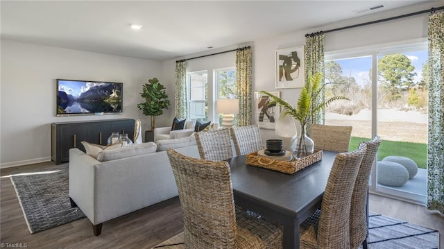 dining room featuring dark hardwood / wood-style floors and a healthy amount of sunlight