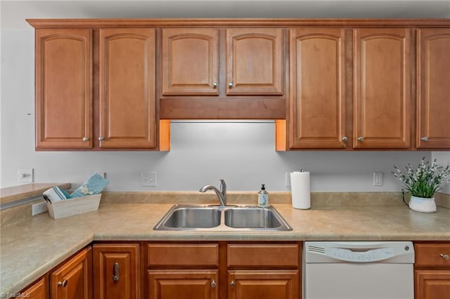 kitchen with brown cabinetry, dishwasher, light countertops, and a sink